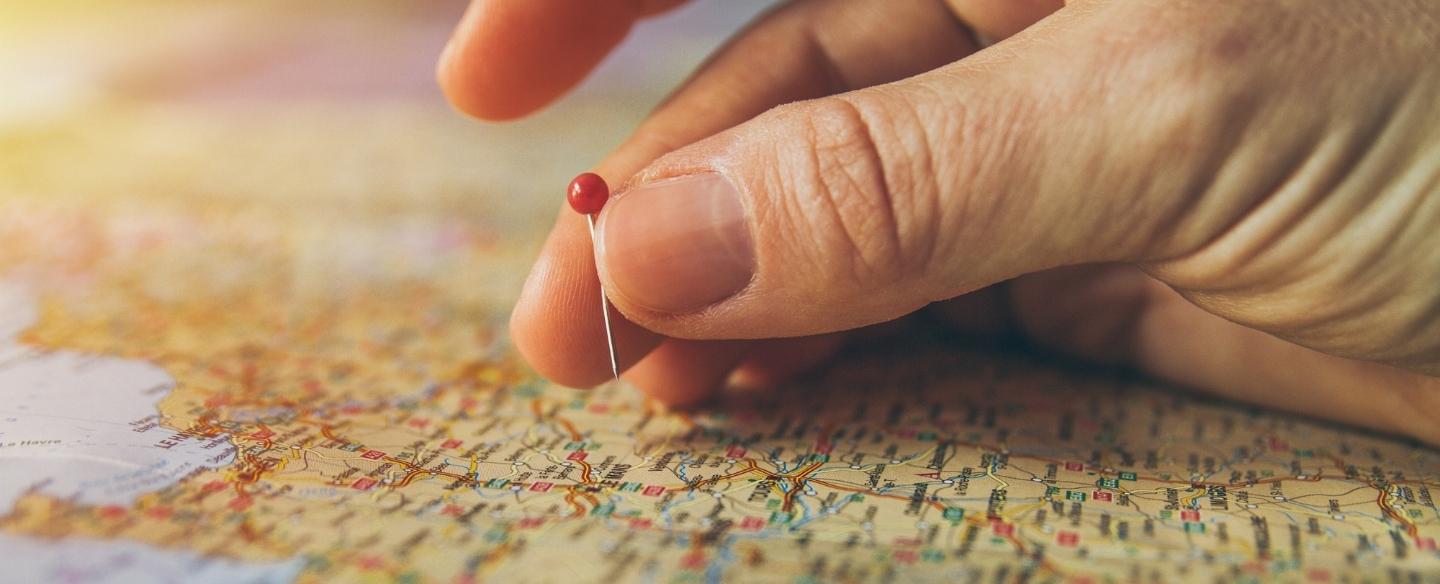 hand putting pin on a map close up barrington il